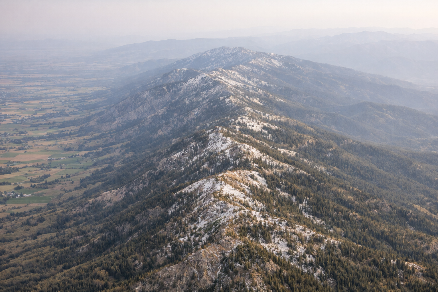 Aerial view of the Bear River Range spine showing the narrow forested ridge above Cache Valley
